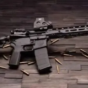 A rifle sitting on top of a wooden floor.