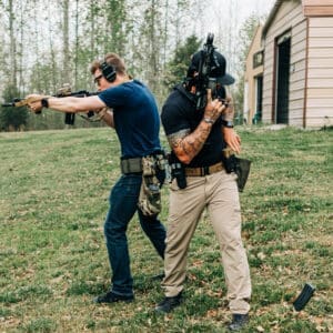 Two men are practicing shooting at a target.