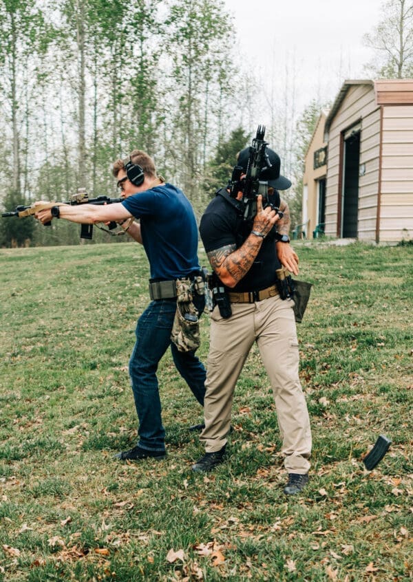 Two men are practicing shooting at a target.