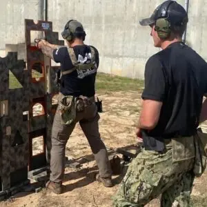 Two men are practicing shooting at a target.