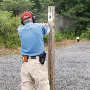 A man is shooting at an event with his gun.