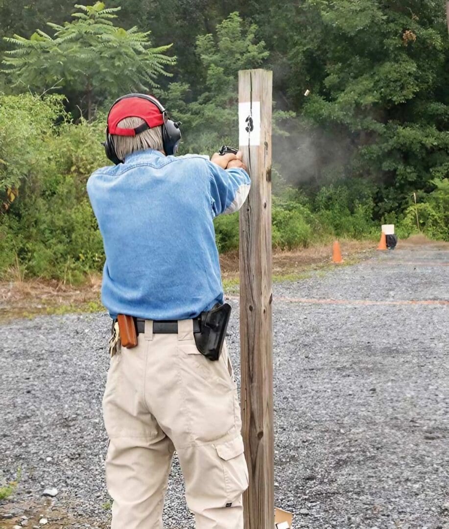 A man is shooting at an event with his gun.