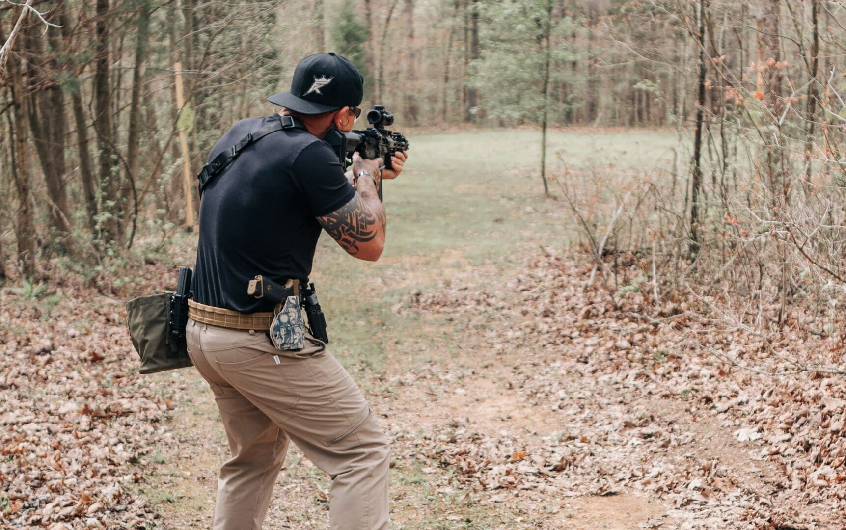 A man taking pictures in the woods with his camera.