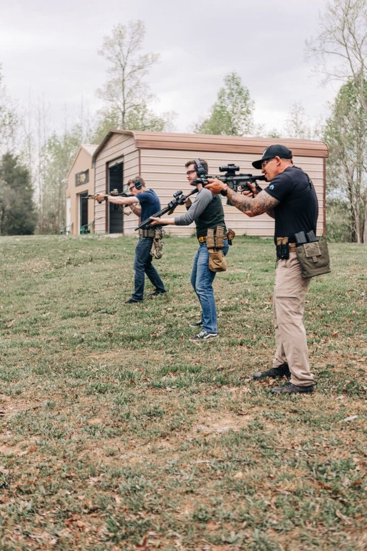 Three men are practicing shooting at a target.