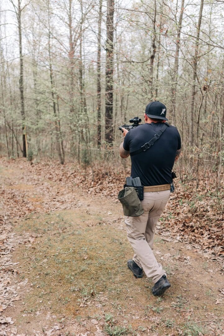 A man is taking pictures in the woods