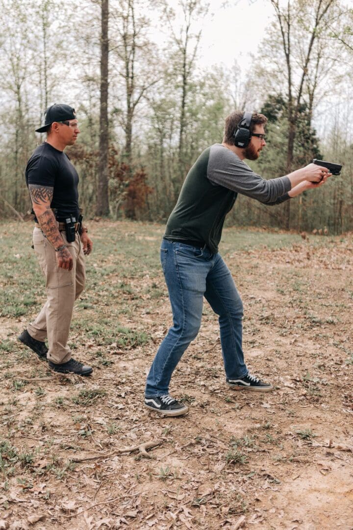 Two men are practicing shooting at a gun range.