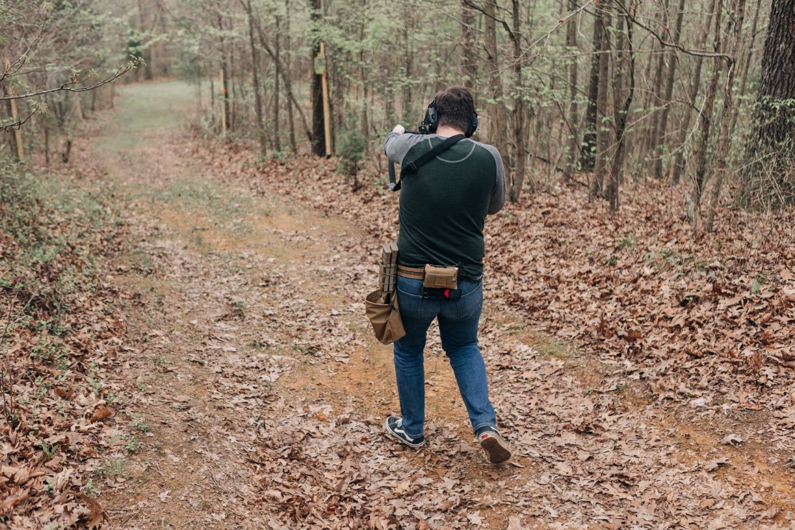 A man is taking pictures in the woods