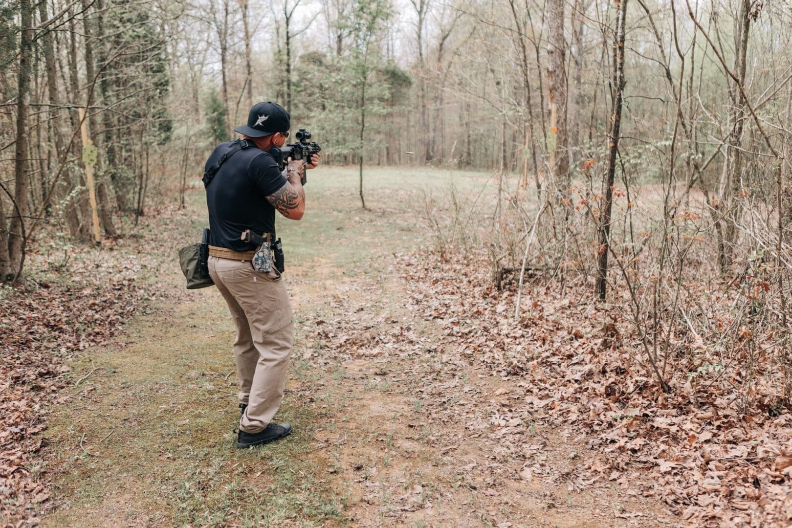 A man taking pictures in the woods with his camera.