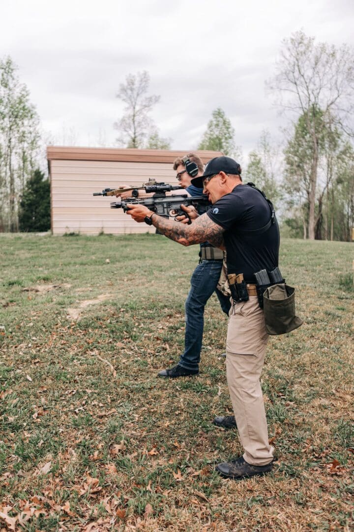 Two men are practicing shooting with rifles.