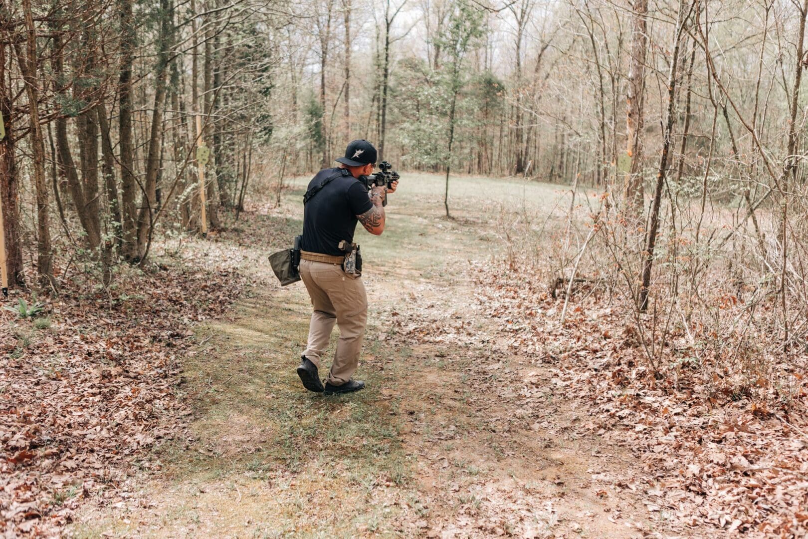 A man taking pictures in the woods with his camera.