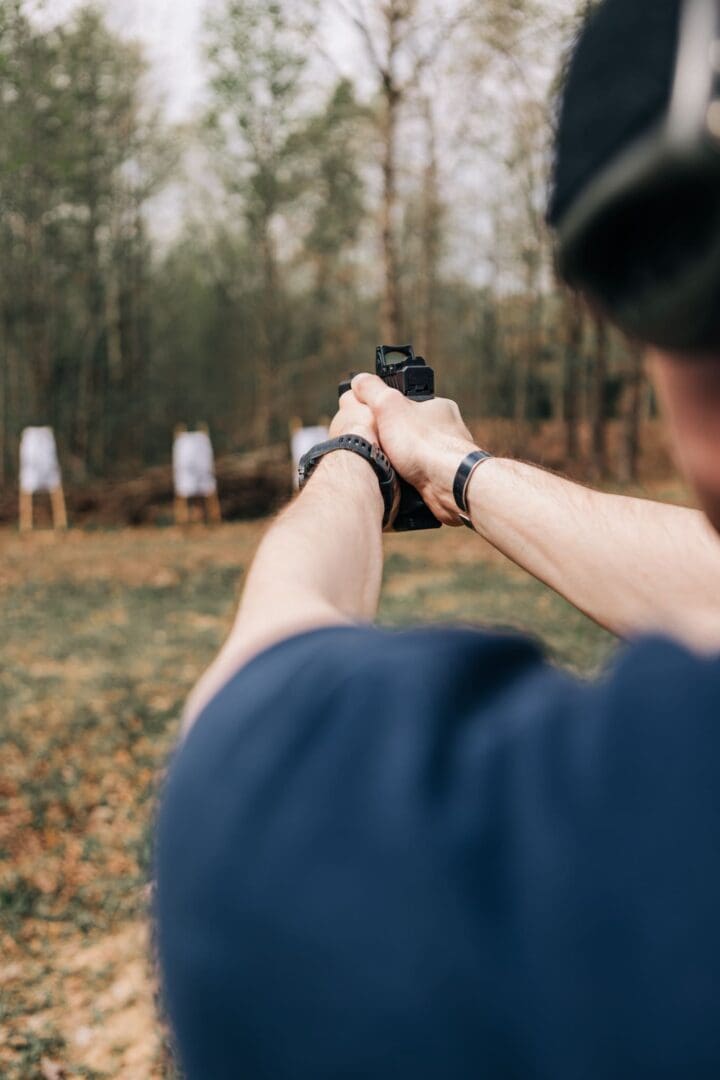 A man holding a gun in his hand.