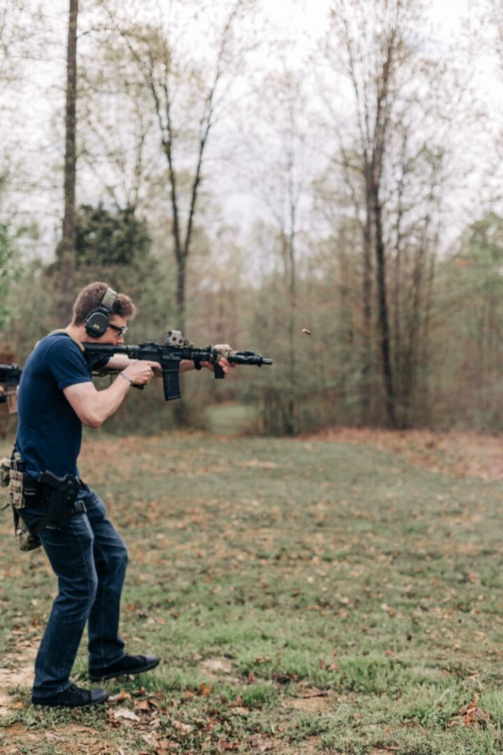 A man holding an ar-1 5 rifle in his hands.