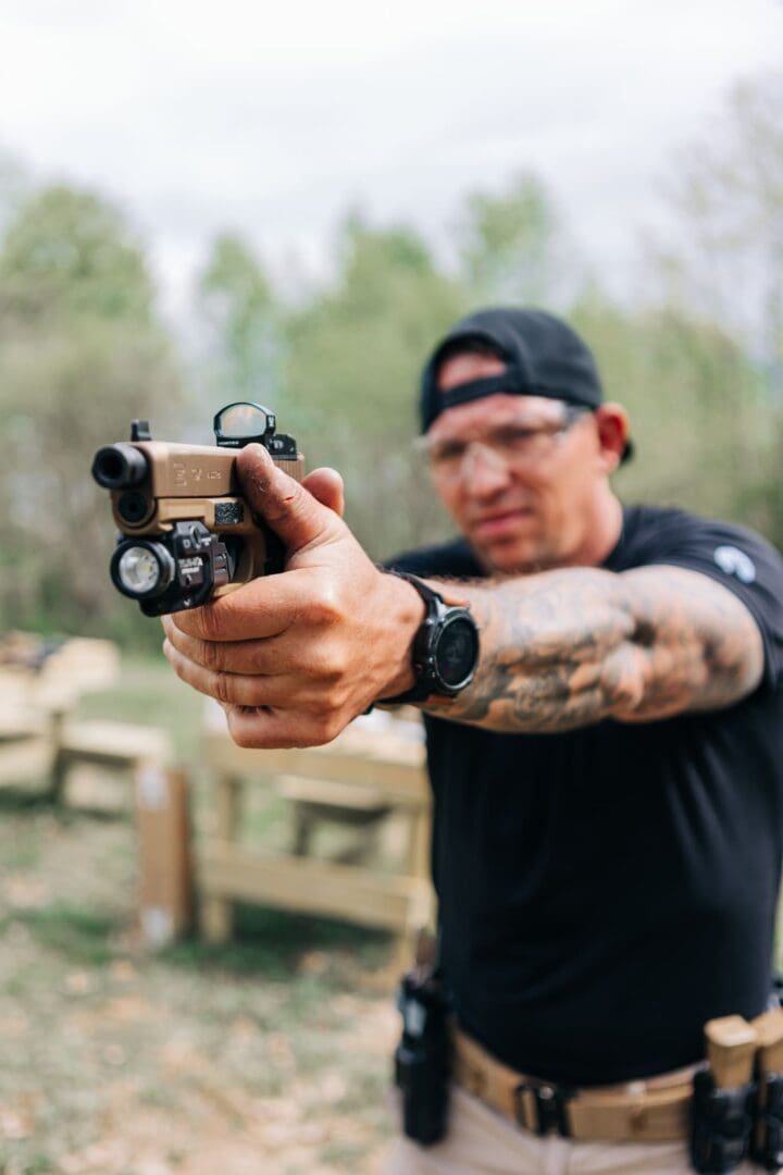 A man holding a gun in his hand.