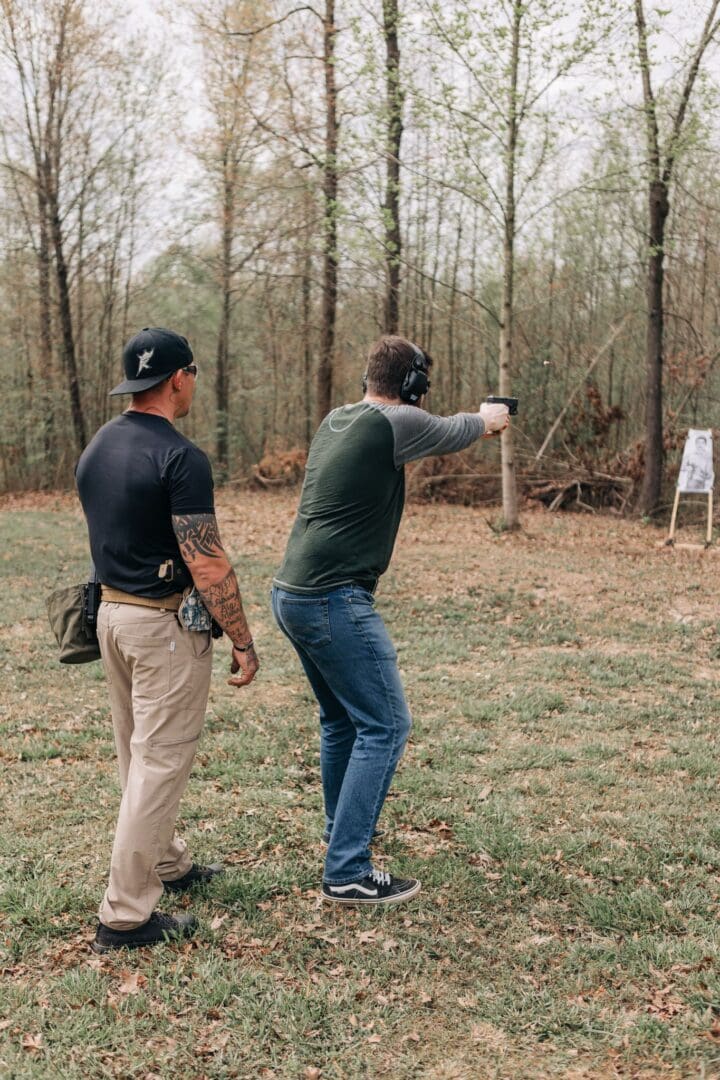 Two men are practicing shooting at a target.