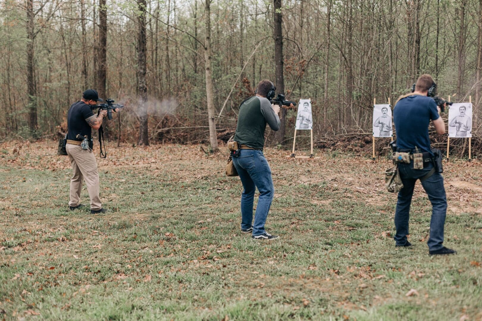 A group of people are shooting guns at targets.