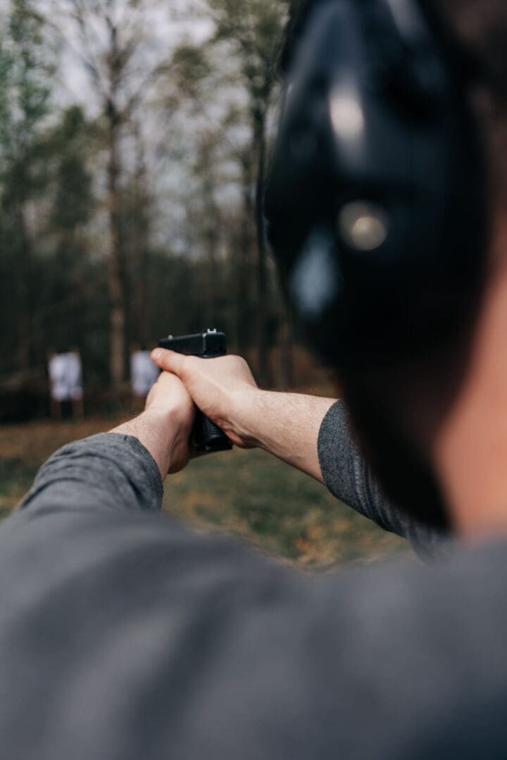 A person holding a gun in their hand.