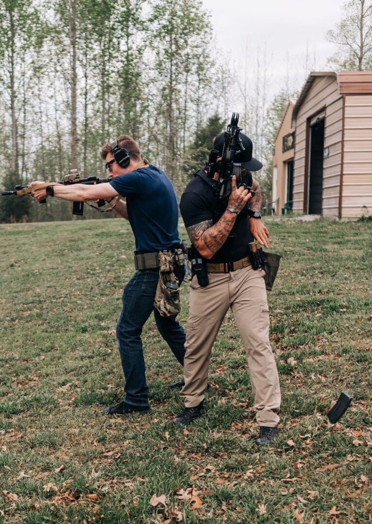 Two men are holding guns and aiming them.