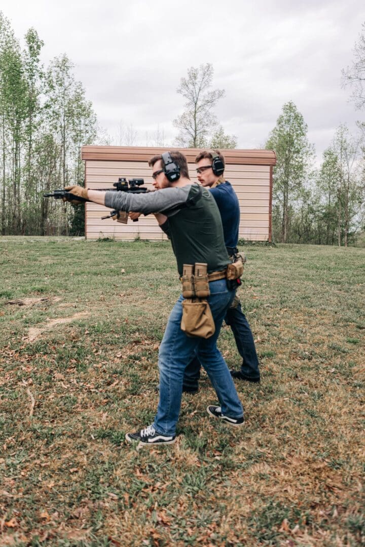 Two men are practicing shooting at a target.