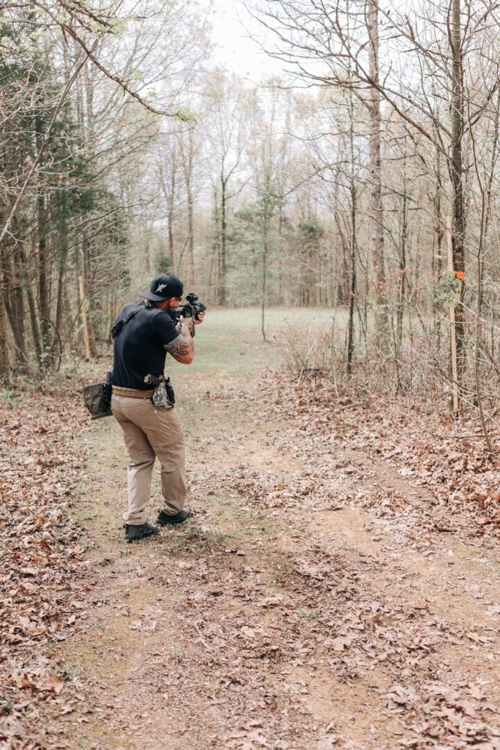 A man taking pictures in the woods with his camera.