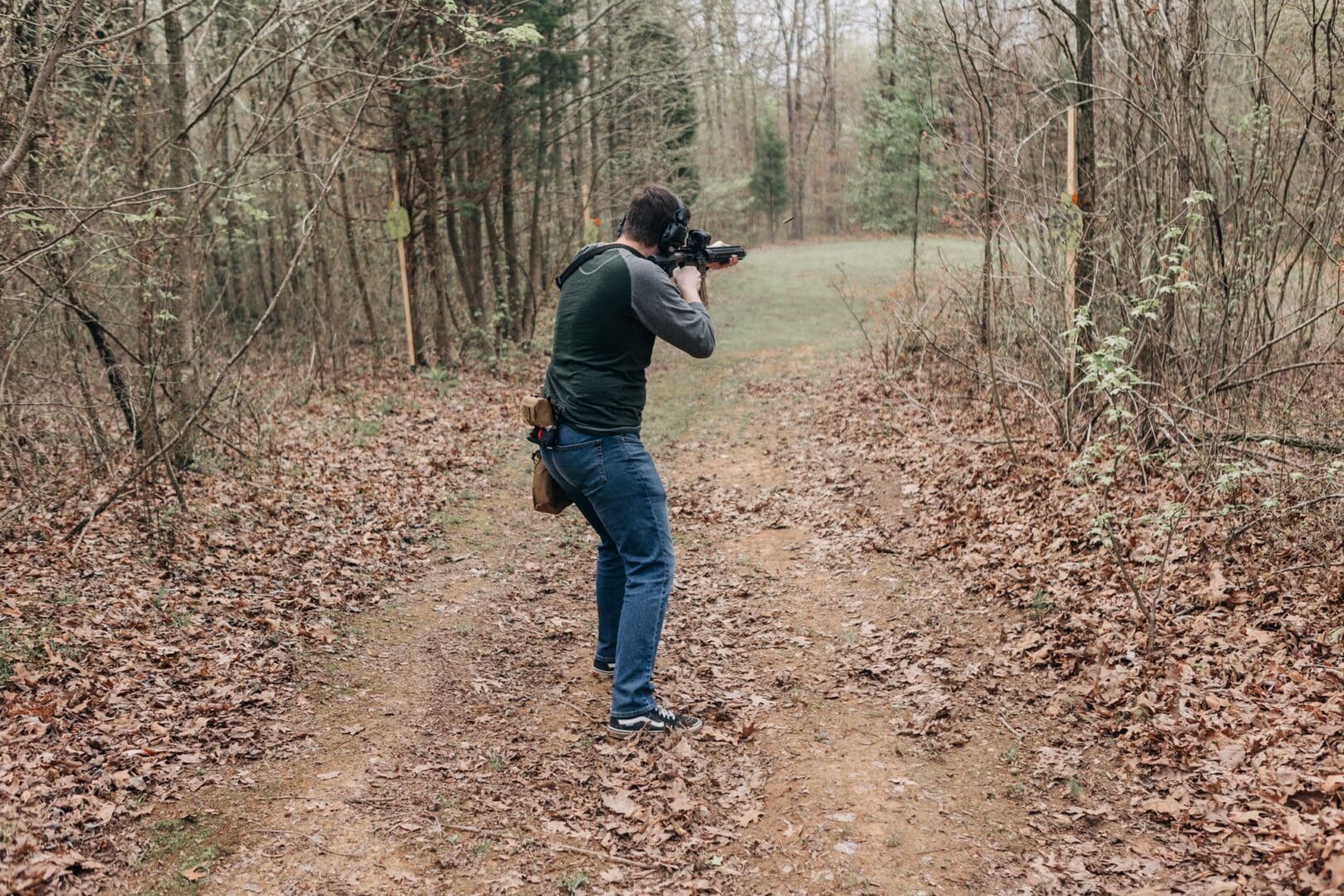 A man is taking pictures in the woods