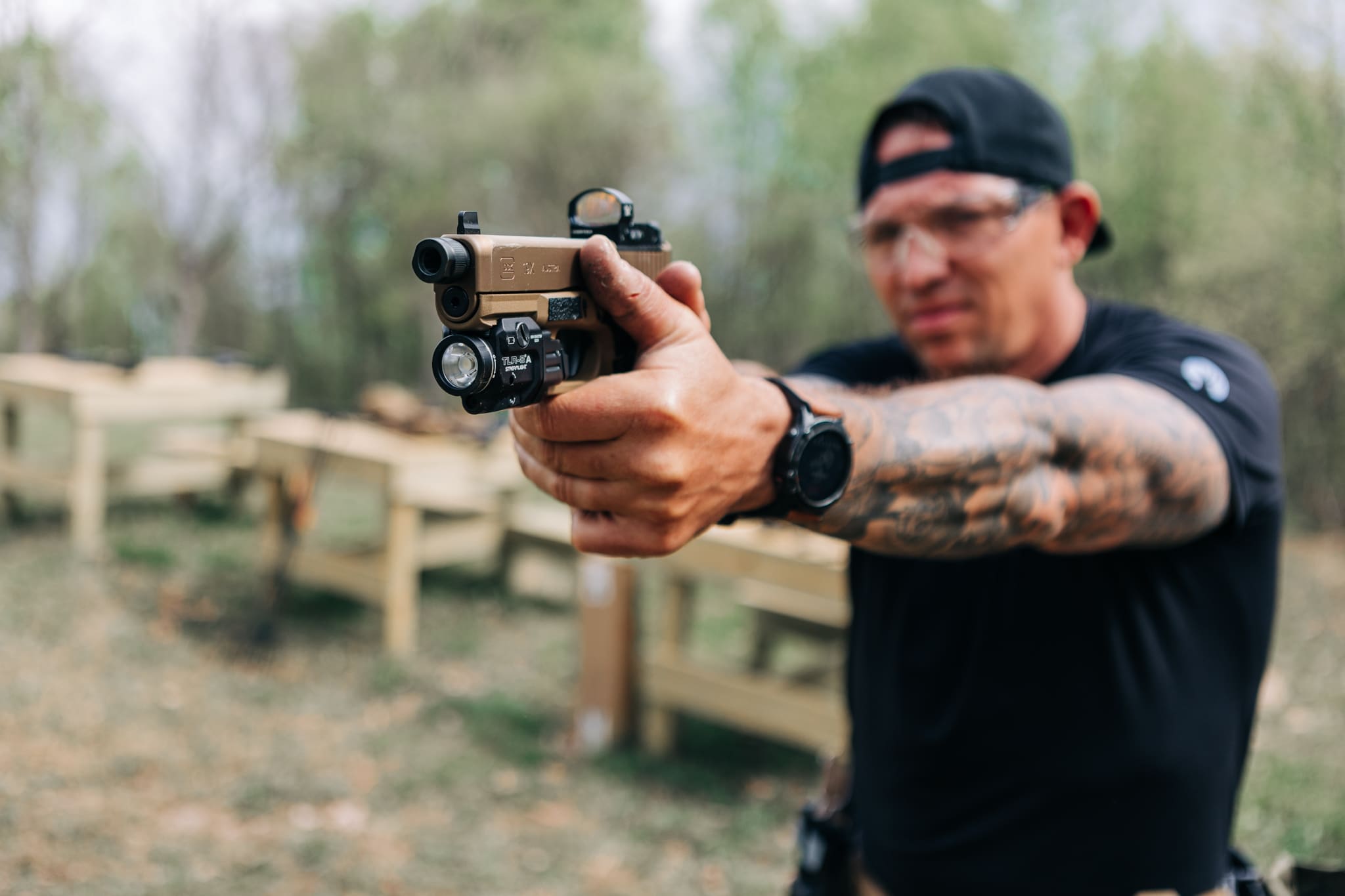 A man holding a gun in his hand.