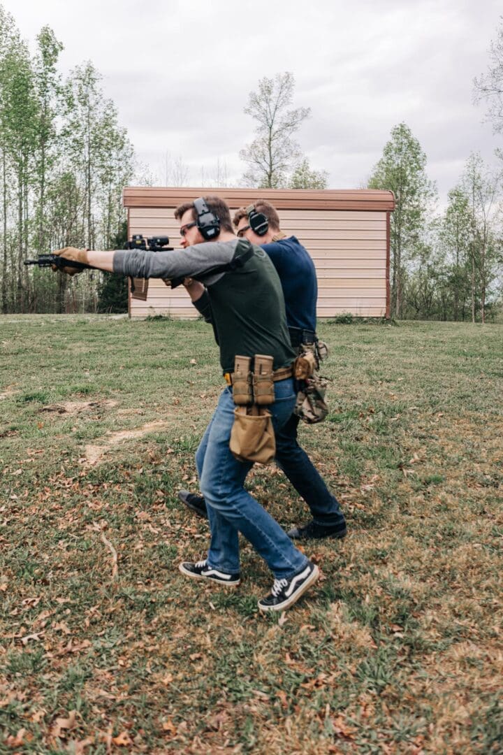 Two men are practicing shooting at a target.