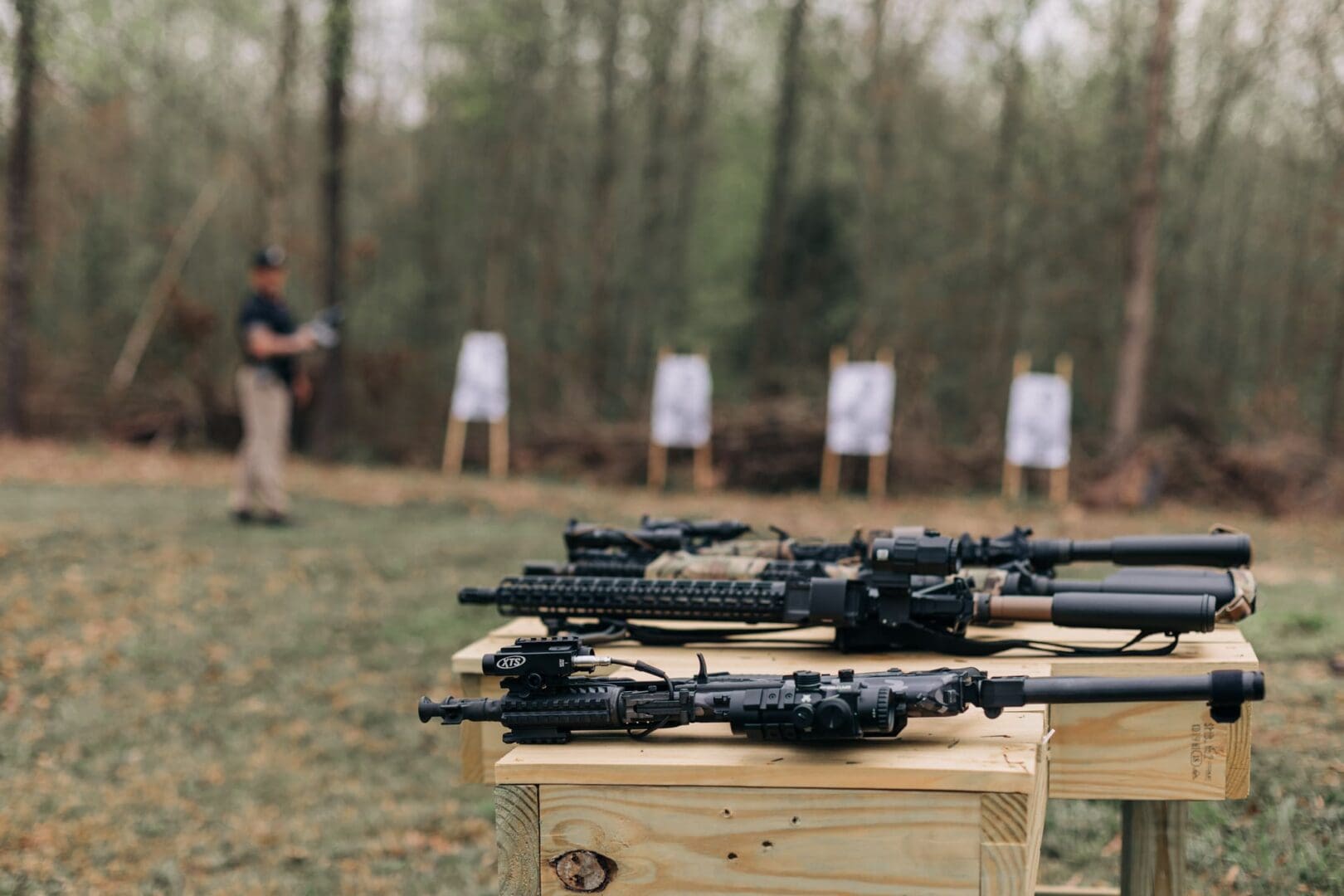 A group of people standing around some guns