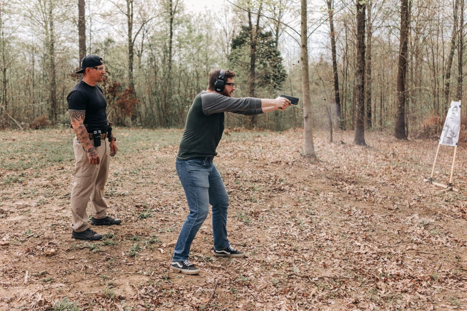 A man is holding a gun and pointing it at something.