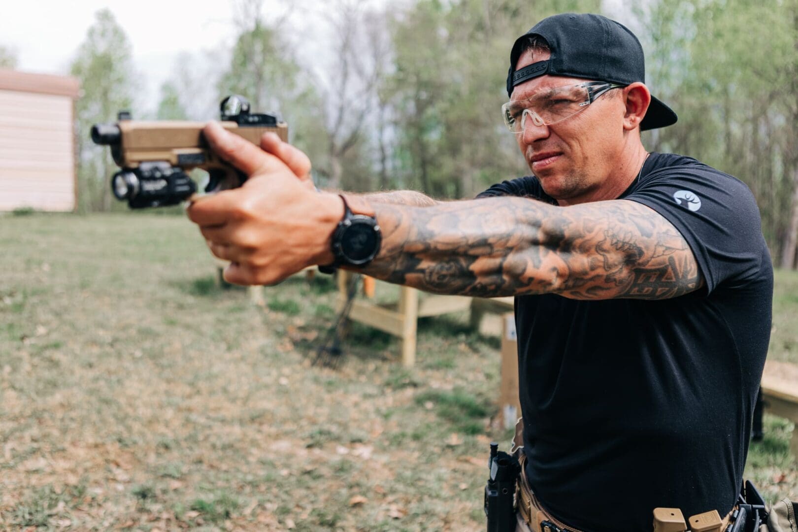 A man holding a gun in his hand.