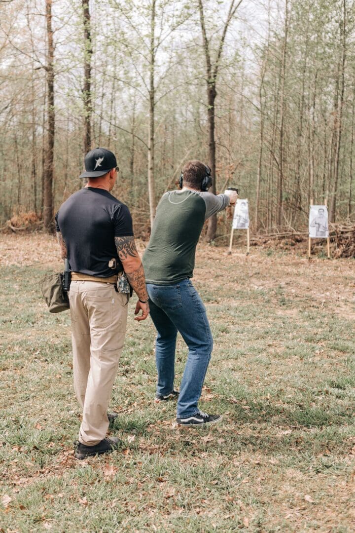 Two men are practicing shooting at a target.