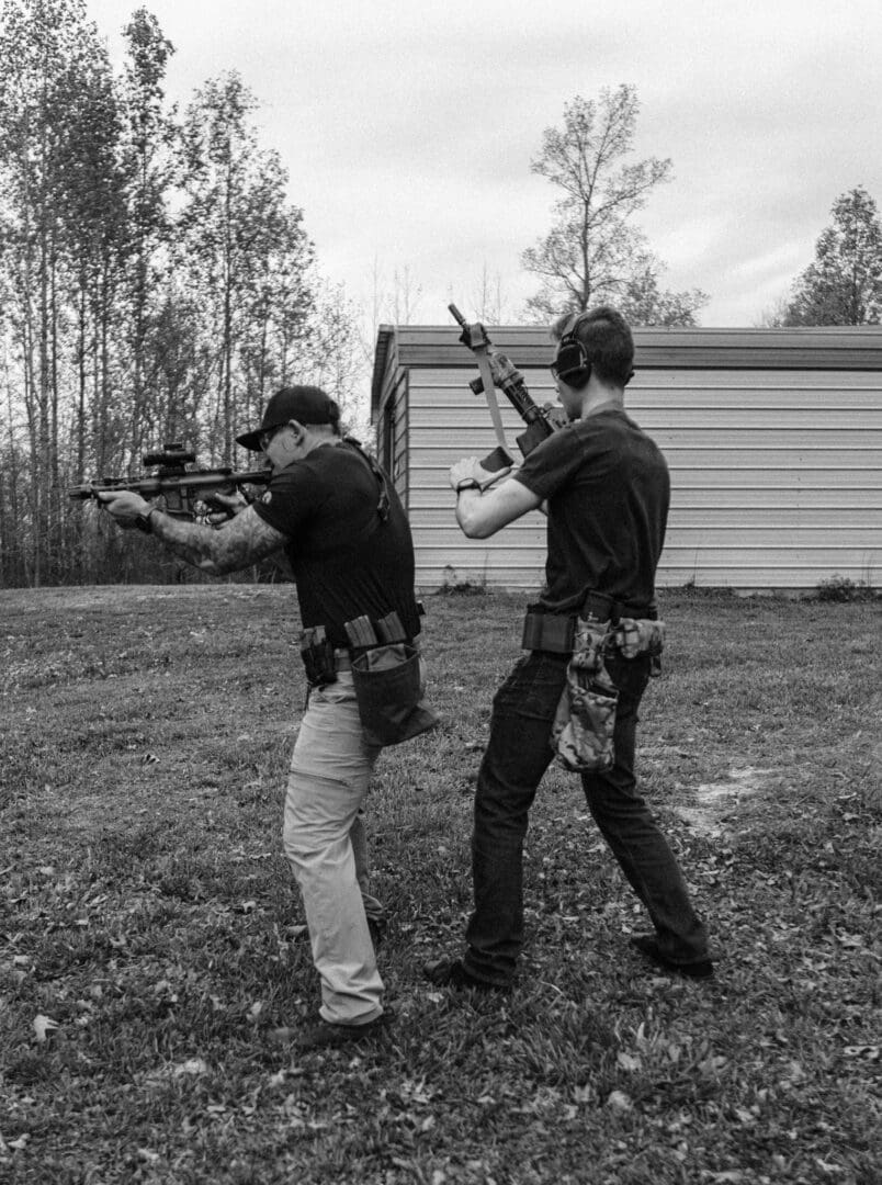 Two men are practicing shooting at a target.