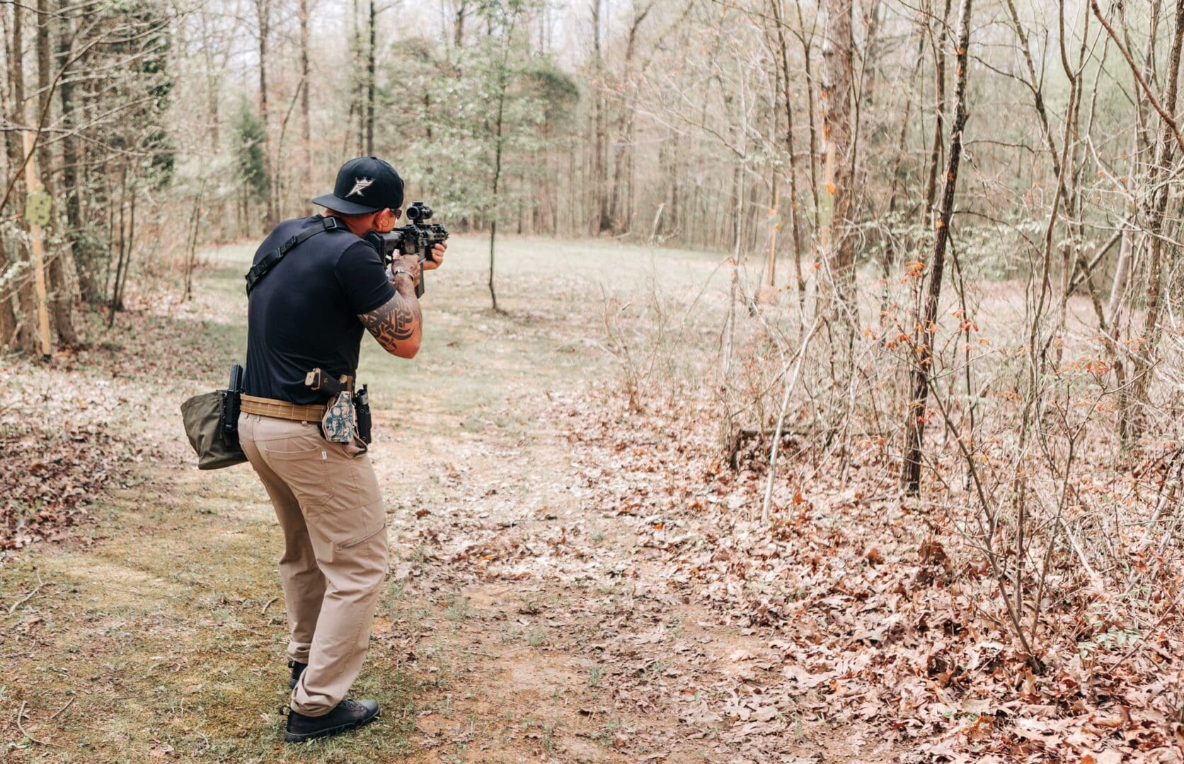 A man taking pictures of the woods with his camera.