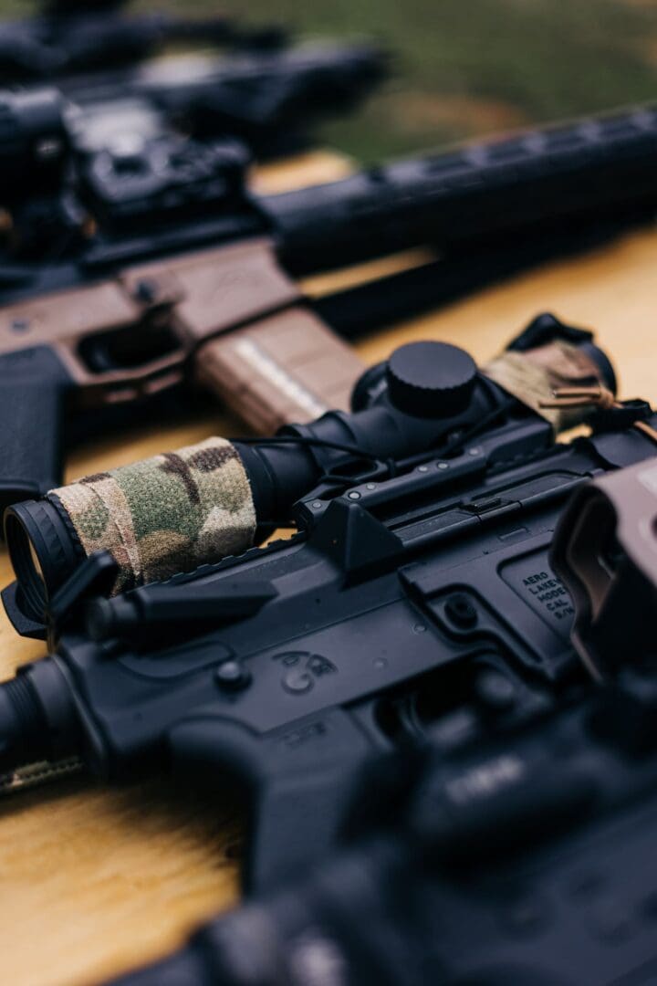 A close up of several different guns on the ground